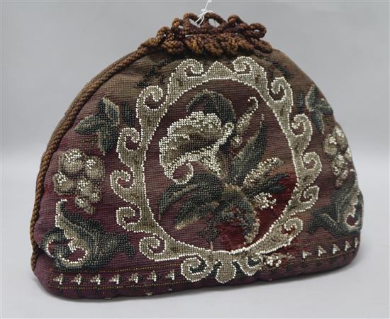 A Victorian beadwork tea cosy and a teapot stand